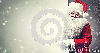 Santa Claus pointing on blank advertisement banner background with copy space Stock Photo