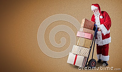 Santa Claus with presents stacked on a delivery trolley in a postal theme with a plain background and copy space Stock Photo