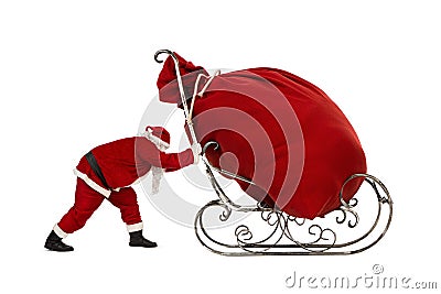 Santa Claus pushing sleigh with huge bag on it Stock Photo