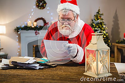 Santa Claus reading a letter Stock Photo