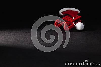 Santa Claus Red Cap on the Red Wodden Carriage in the dark room Stock Photo