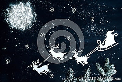 Santa Claus and reindeer flying through the night sky. Stock Photo