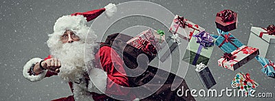Santa Claus running and delivering gifts Stock Photo