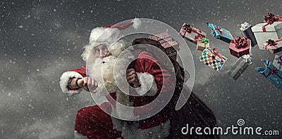 Santa Claus running and delivering gifts Stock Photo