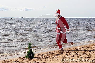 Santa claus is running with gifts delivery vacation christmas new year Stock Photo