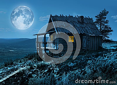 Santa`s secret cottage in magic moonlight Stock Photo