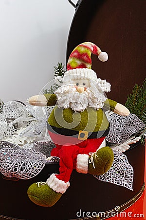 Santa Claus sits on vintage brouwn coffer with white christmas t Stock Photo