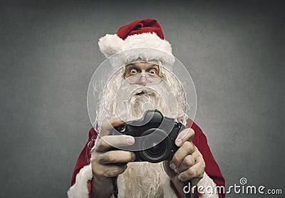 Santa Claus taking holiday pictures Stock Photo