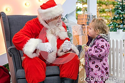 Santa Claus talking with little girl in Shopping Mall. Christmas wishes. 13dec2019 St-Petersburg Russia Editorial Stock Photo