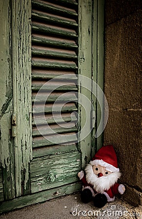 Santa Claus, doll toy, next to the wooden shutters Editorial Stock Photo