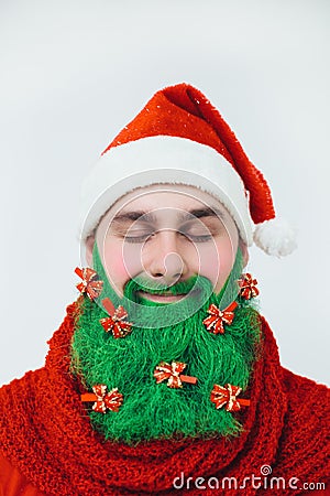 Santa Clause in red clothes with green beard smiles Stock Photo