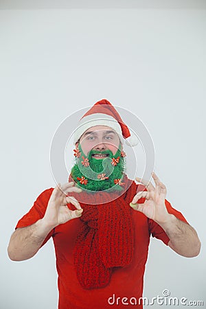 Santa Clause in red clothes with green beard smiles Stock Photo