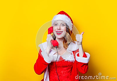 Santa Clous girl in red clothes with handset Stock Photo