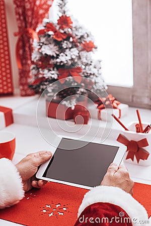 Santa connecting with a tablet Stock Photo