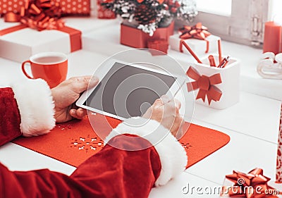Santa connecting with a tablet Stock Photo