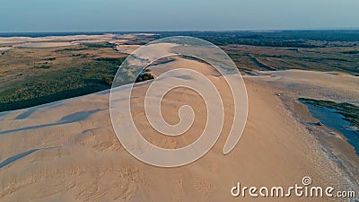aerial picture of a beautiful blue lagoon next to the desert sand dunes Stock Photo