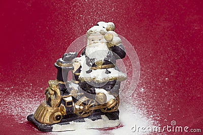 Decorative Santa figurine and snowing on red background Stock Photo