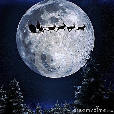 Santa flying in his sleigh against a full moon background Stock Photo