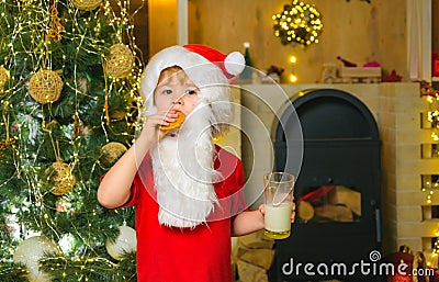 Santa fun. Merry Christmas. Santa - funny child picking cookie. Santa Claus takes a cookie on Christmas Eve as a thank Stock Photo