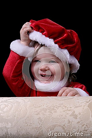 Santa Girl Removing Hat Stock Photo