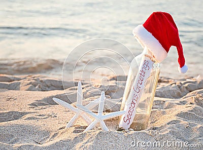 Santa hat on message in bottle with starfish Stock Photo