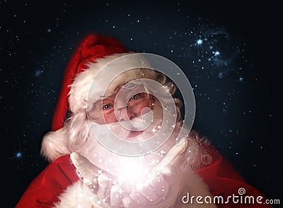 Santa holding magical Christmas lights in hands Stock Photo