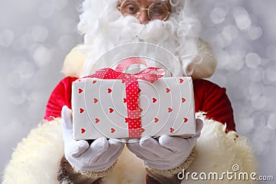 Santa holds a big red box, gifts, sales, shows the postage, the concept of the international holiday delivery of goods, christmas Stock Photo