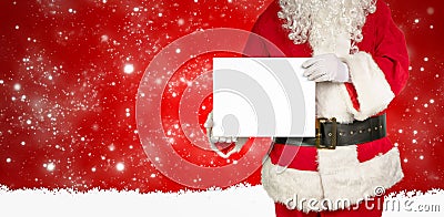 Santa holds an empty white panel for advertising in the camera Stock Photo