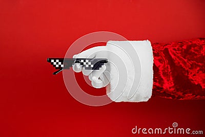 Santa holds funny swag pixilated boss sunglasses on red background. Gangster, Black thug life meme glasses. Pixel 8bit style Stock Photo