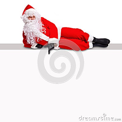 Santa lying on a blank billboard sign Stock Photo