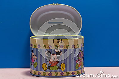 Old tin piggy bank disney collection with Mickey mouse print Editorial Stock Photo