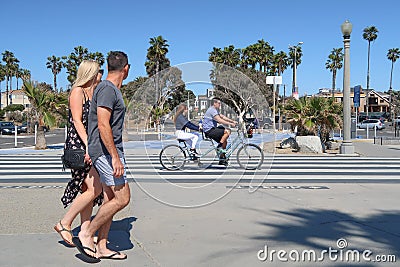 Santa Monica, California, USA 03.31.2017 man and woman riding tandem bicycle on Ocean Front Walk Editorial Stock Photo