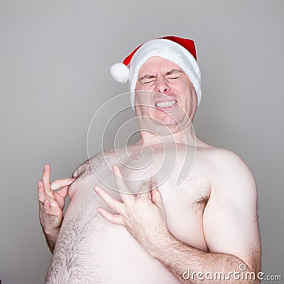 Santa pinching his nipples Stock Photo