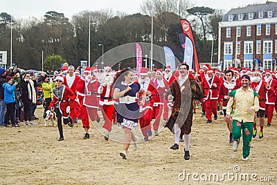 Santa Run on Weymouth beach having fun Editorial Stock Photo