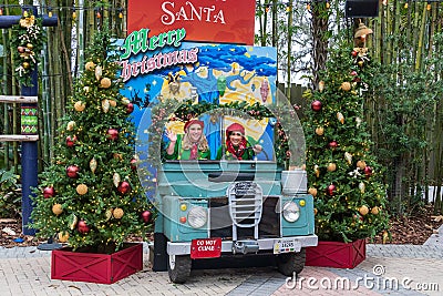 Santa`s elves pose in a Land Rover at the Christmas in the Wild Holiday event, in ZooTampa at Lowry Park - Tampa, Florida, USA Editorial Stock Photo