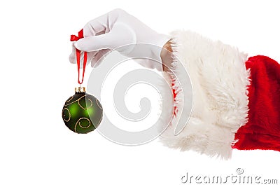 Santa's hand holding a green Christmas ornament Stock Photo