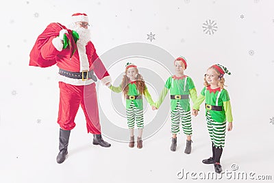 Santa`s helpers working at North Pole. He Reading wishes list Stock Photo