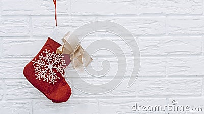 Santa`s red stocking. Concept of christmas or holiday. Red and white Christmas stocking, Santa Claus sock hanging from a Stock Photo