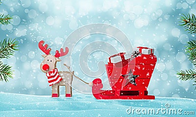 Santa`s sleigh full of gifts in snow. Deer pulls the sled. Cute wooden toy Stock Photo