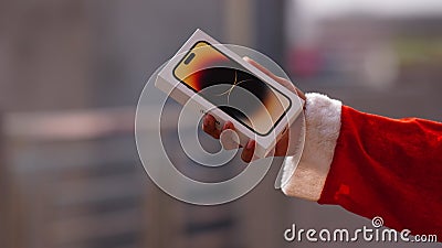 santa showing Iphone 14 pro in santa's hand gift iphone Editorial Stock Photo