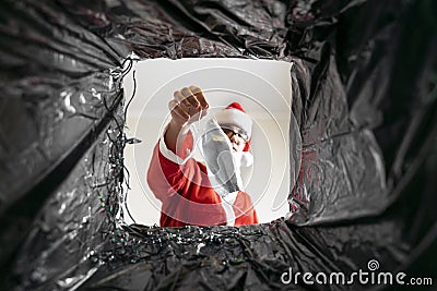 Santa throws a disposable mask in the trash. covid dissident Stock Photo