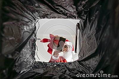 Santa throws gifts in the trash Stock Photo