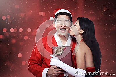 Santa woman give kiss to her lover Stock Photo