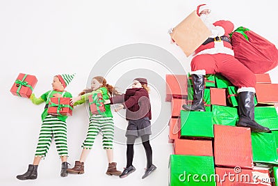 Santa's helpers working at North Pole. He Reading wishes list Stock Photo