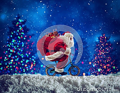 Santaclaus rides bike to deliver fast christmas gifts Stock Photo