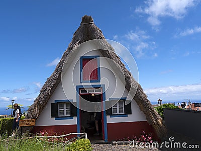 Santana in Madeira is a beautiful village on the north coast. is known by its small thatched triangular houses. Dragon Trees and f Editorial Stock Photo