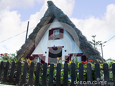 Santana in Madeira is a beautiful village on the north coast. is known by its small thatched triangular houses. Dragon Trees and f Editorial Stock Photo