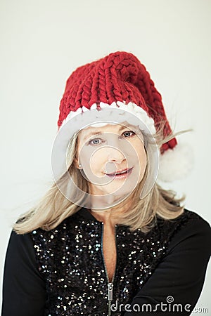 Santas little helper. Beautiful happy senior woman with a santa claus hat Stock Photo