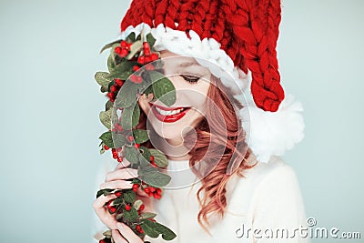 Santas little helper. Beautiful happy young woman with a santa claus hat Stock Photo