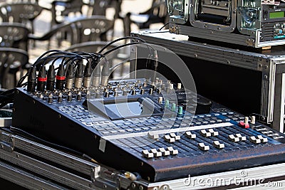 Music mixer on outdoors, mixing table with buttons and volume controls Editorial Stock Photo